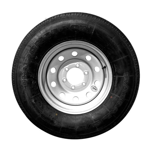 A close-up image of a 8 Lug Tire featuring a black tire with a silver, multi-hole rim. The tire's sidewall prominently displays the brand name "DIAMONDBACK" and the word "RADIAL ST". The tire is positioned upright, showcasing its tread pattern and valve stem clearly.