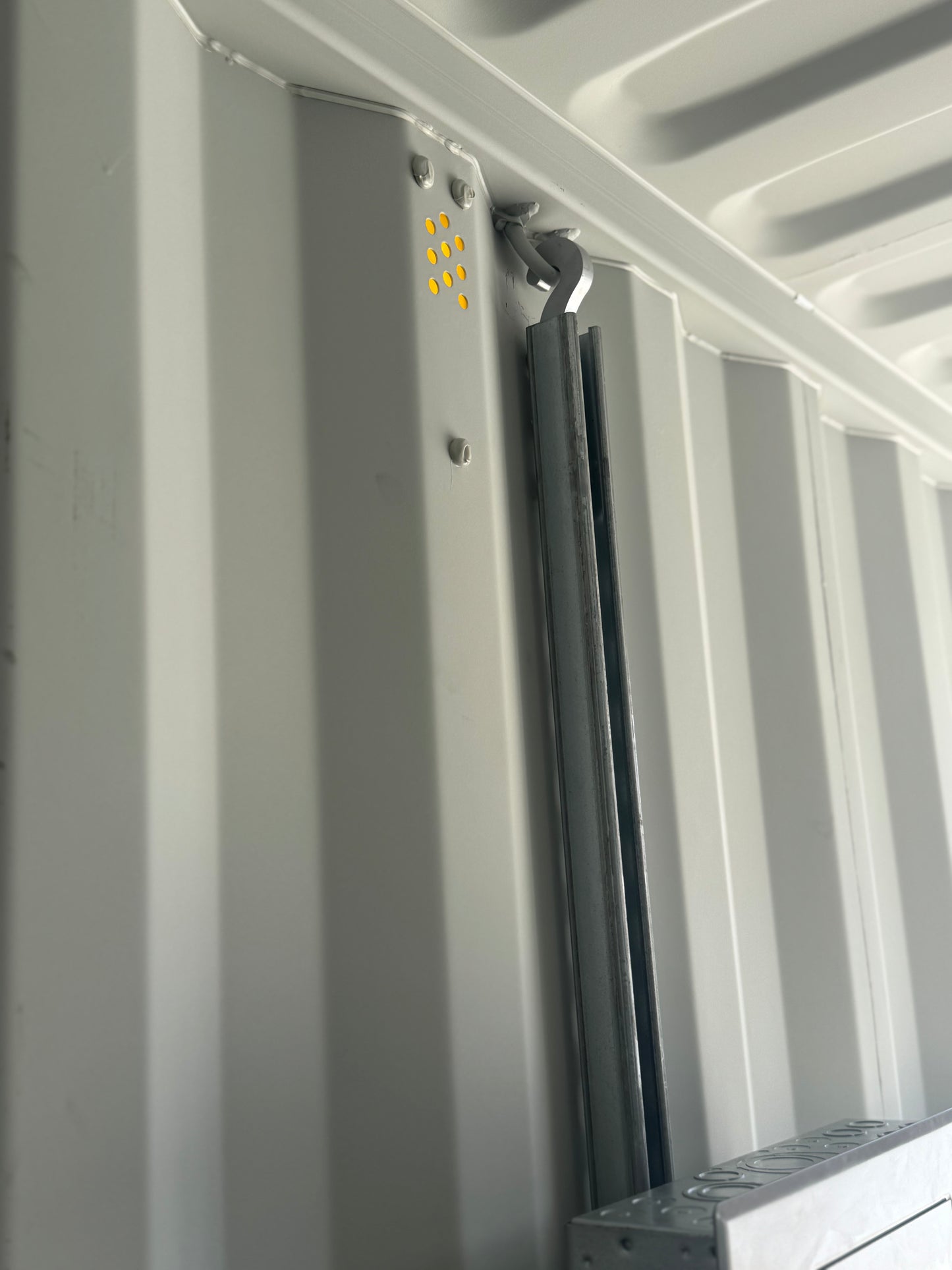 Strut channel detail showing one hooked mounting point secured with fasteners near the top.