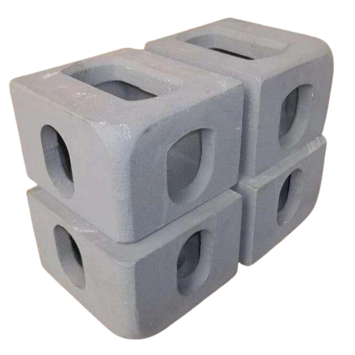 Four ISO Corner Castings from Container Nut are neatly stacked in an alternating pattern. Each casting has a hole in the center. 