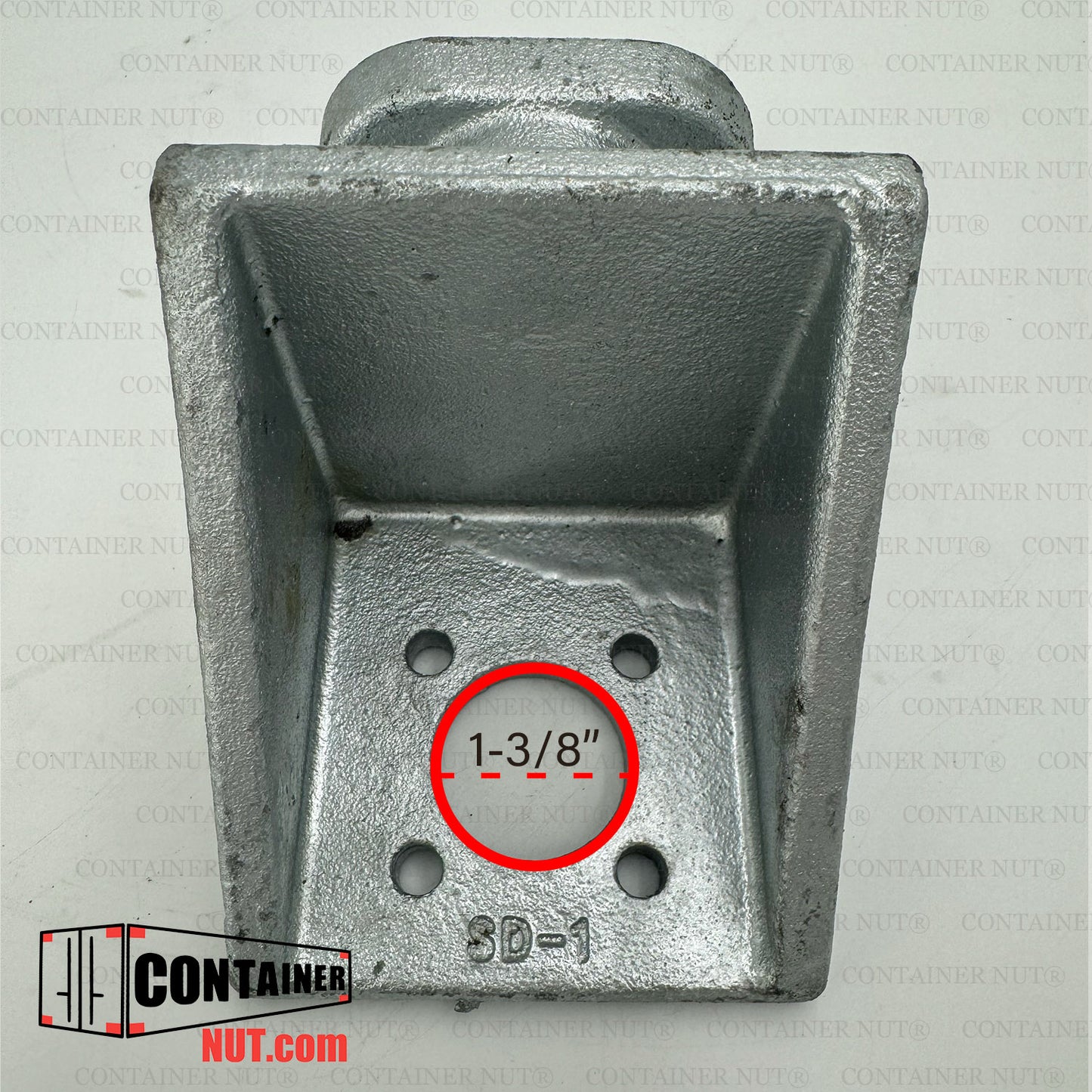 A close-up image of a galvanized twist lock fitting for a shipping container. The fitting is rectangular and has four bolt holes at the base. The measurement "1-3/8" is displayed in a red circle over one of the holes. A logo reads "ContainerNut.com".