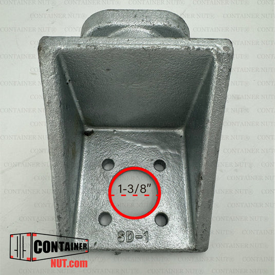 A close-up image of a galvanized twist lock fitting for a shipping container. The fitting is rectangular and has four bolt holes at the base. The measurement "1-3/8" is displayed in a red circle over one of the holes. A logo reads "ContainerNut.com".